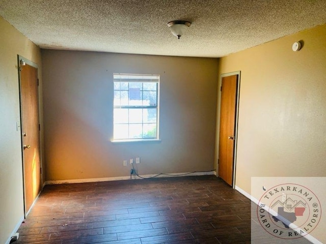 unfurnished bedroom featuring a closet, dark hardwood / wood-style flooring, and a textured ceiling