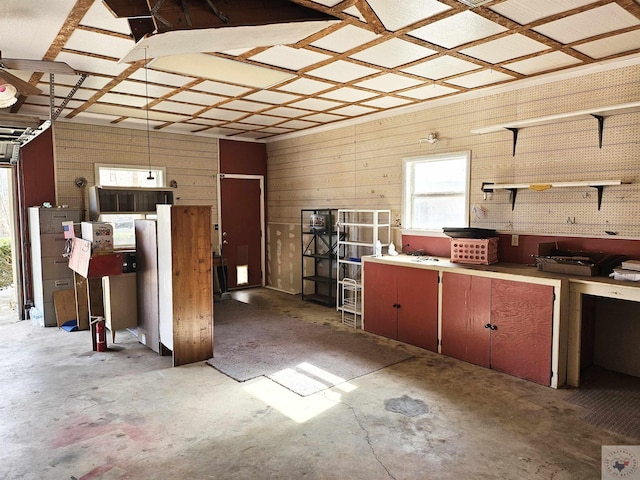 interior space with wooden walls and a workshop area