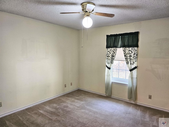 spare room with ceiling fan, a textured ceiling, and carpet flooring