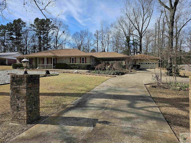 ranch-style home featuring a garage, a front yard, and covered porch