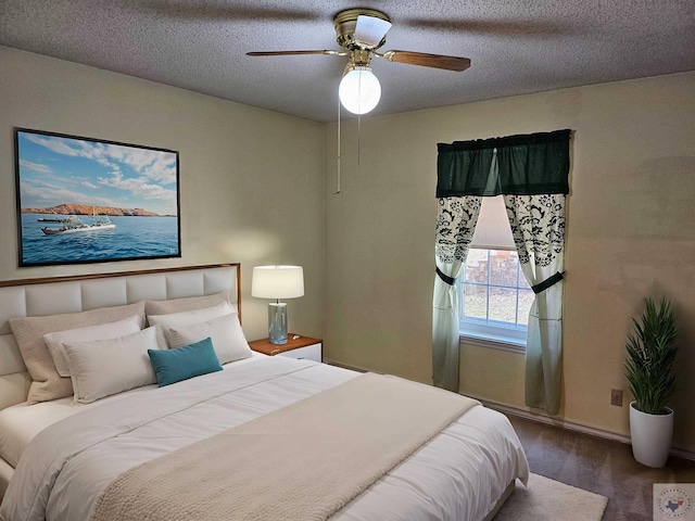 bedroom with a textured ceiling and ceiling fan