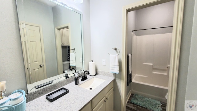 full bathroom with vanity, shower / tub combination, and toilet