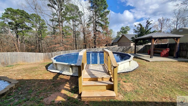view of pool featuring a gazebo, a yard, and a patio area