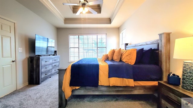 carpeted bedroom featuring a raised ceiling, crown molding, and ceiling fan