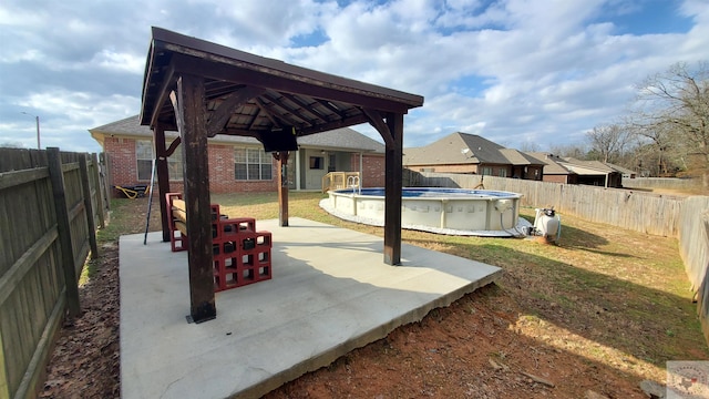 view of patio featuring a fenced in pool and a gazebo