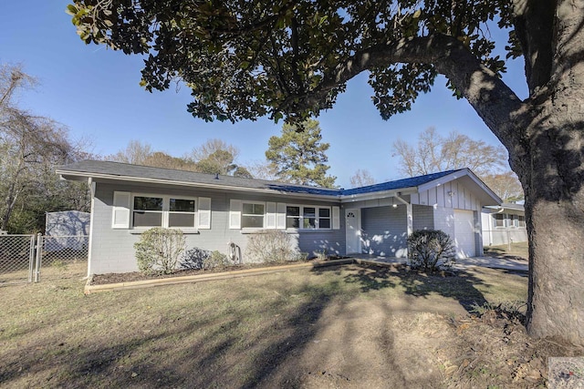 single story home featuring a front yard and a garage