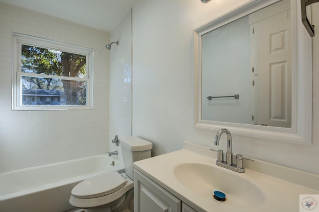 full bathroom with vanity, toilet, and tiled shower / bath combo