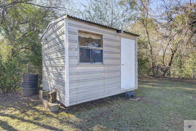 view of outbuilding featuring a lawn