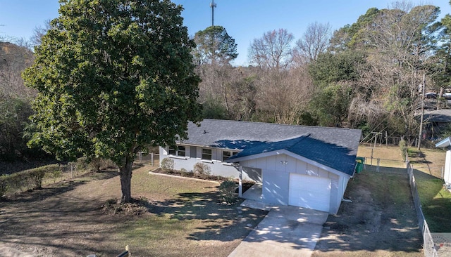 view of front of house featuring a garage, a front yard, and an outdoor structure