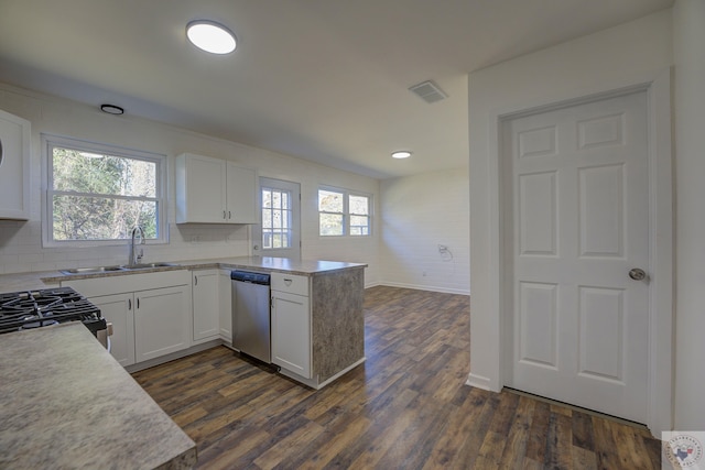 kitchen with sink, white cabinetry, stainless steel dishwasher, and dark hardwood / wood-style flooring