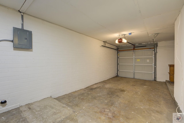 garage with electric panel and a garage door opener