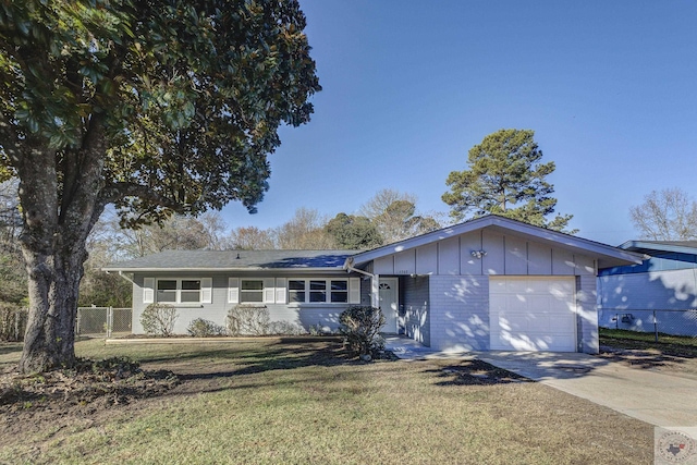 single story home with a garage and a front lawn