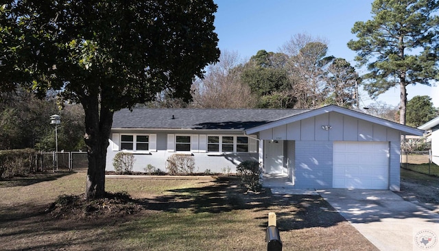 ranch-style house featuring a garage and a front yard