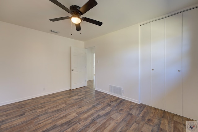 unfurnished bedroom with a closet, ceiling fan, and dark hardwood / wood-style floors