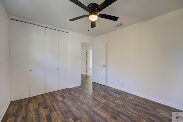 unfurnished bedroom featuring a closet, ceiling fan, and dark hardwood / wood-style floors