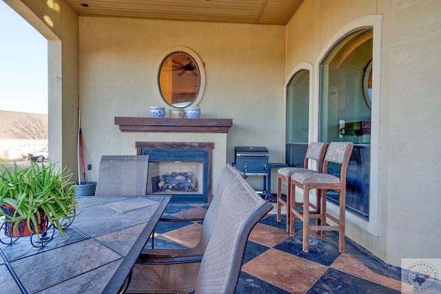 view of patio with an outdoor fireplace