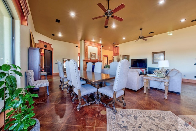 dining space with ceiling fan and a towering ceiling