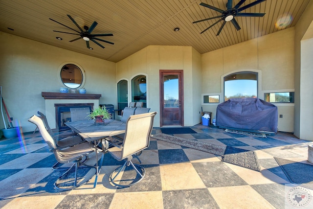 view of patio / terrace with ceiling fan and exterior fireplace