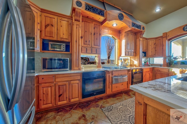 kitchen featuring dark tile patterned flooring and appliances with stainless steel finishes