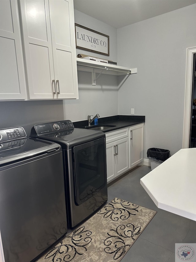 washroom featuring sink, cabinets, and separate washer and dryer