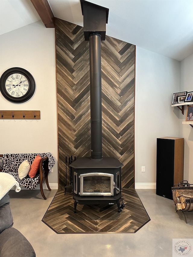 details with a wood stove and concrete floors