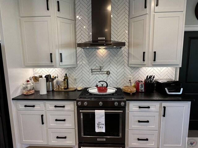 kitchen with white cabinetry, gas stove, and wall chimney exhaust hood