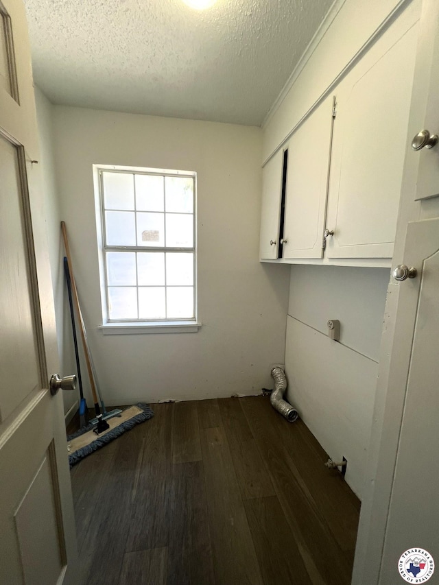 4320 Jefferson Ave, Texarkana, AR 71854 - washroom with dark wood-style flooring, a textured ceiling, and cabinet space