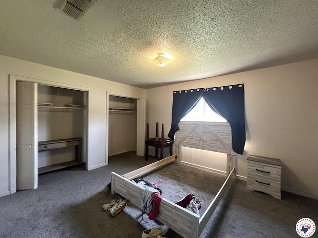 4320 Jefferson Ave, Texarkana, AR 71854 - carpeted bedroom with multiple closets and a textured ceiling