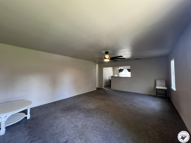 4320 Jefferson Ave, Texarkana, AR 71854 - unfurnished living room featuring dark colored carpet and ceiling fan