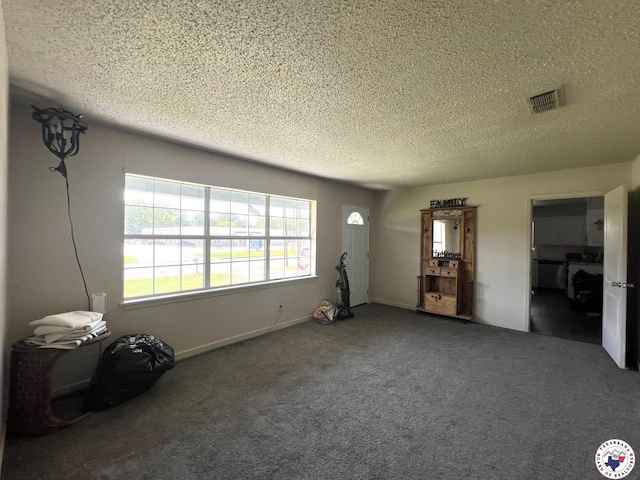 4320 Jefferson Ave, Texarkana, AR 71854 - unfurnished living room featuring a textured ceiling and carpet flooring