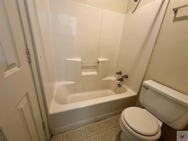 bathroom featuring toilet and washtub / shower combination