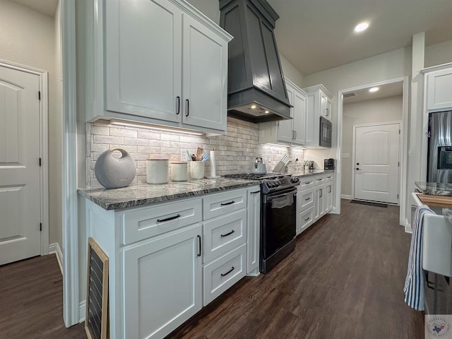 375 Fm 2149, New Boston, TX 75570 - kitchen with light stone counters, dark wood-type flooring, custom exhaust hood, black appliances, and tasteful backsplash