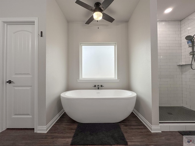 375 Fm 2149, New Boston, TX 75570 - bathroom featuring ceiling fan, wood finished floors, baseboards, a soaking tub, and a shower stall