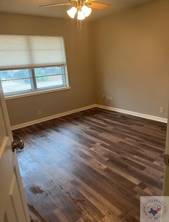 empty room with dark wood-type flooring and ceiling fan