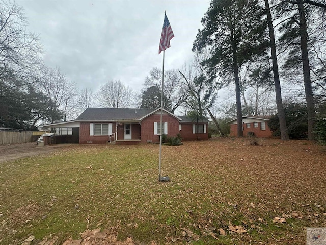 ranch-style home with a front yard and a carport