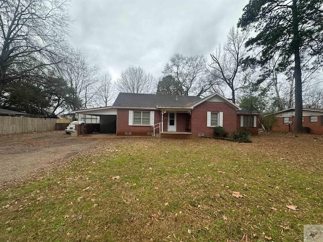 single story home featuring a front lawn and a carport