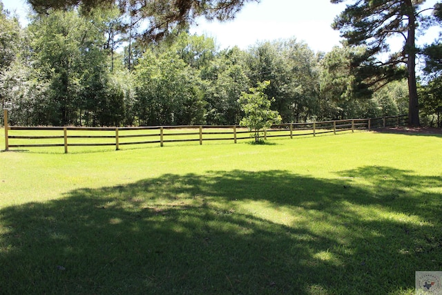 view of yard featuring a rural view and fence