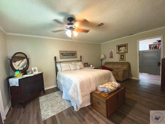 bedroom with a textured ceiling, visible vents, wood finished floors, and ornamental molding