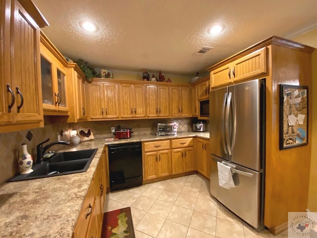 kitchen featuring black appliances, light tile patterned floors, light countertops, and a sink