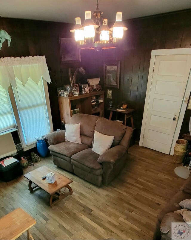 living room featuring a chandelier and hardwood / wood-style floors