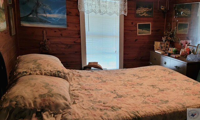 bedroom with wood walls