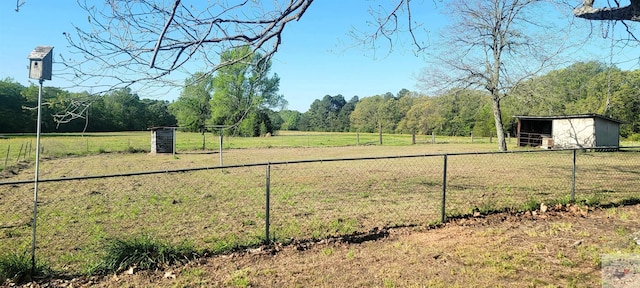 view of yard featuring an outbuilding and a rural view