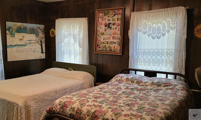 bedroom featuring wood walls