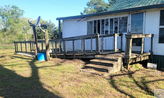 exterior space featuring a lawn and a wooden deck