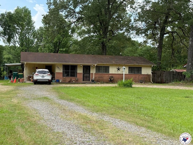 2803 Johnson Ln, Texarkana, TX 75501 - single story home with fence, brick siding, driveway, a carport, and a front lawn