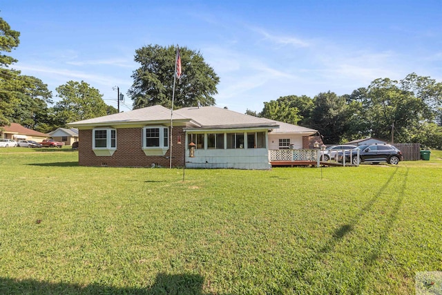 rear view of property with a yard