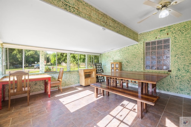 sunroom / solarium featuring ceiling fan