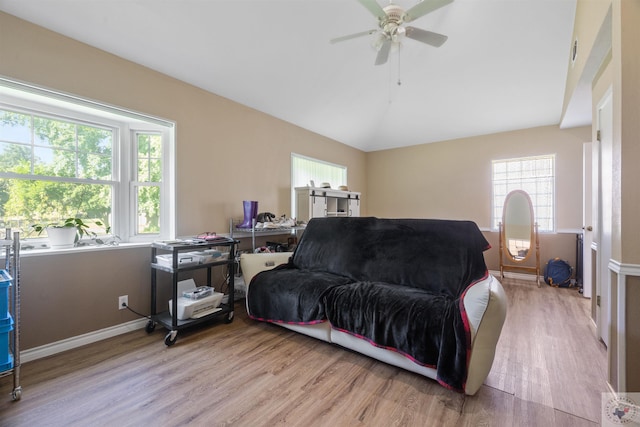 living room with a healthy amount of sunlight and light hardwood / wood-style flooring