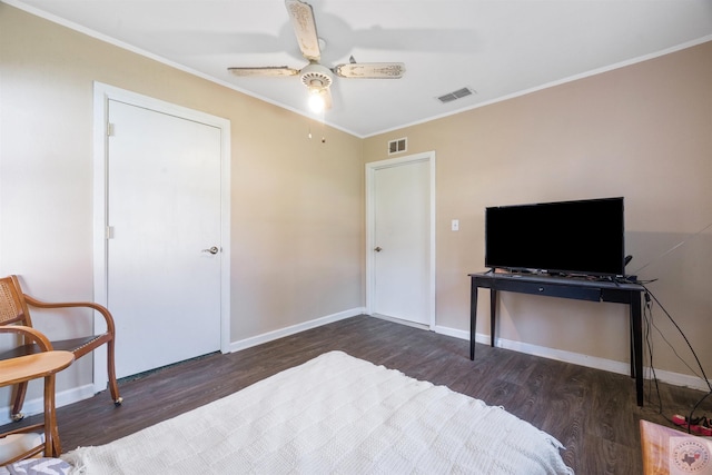 bedroom with ceiling fan, dark wood-type flooring, and ornamental molding