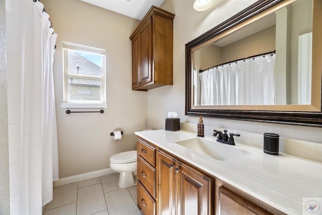 bathroom featuring vanity, toilet, and tile patterned flooring